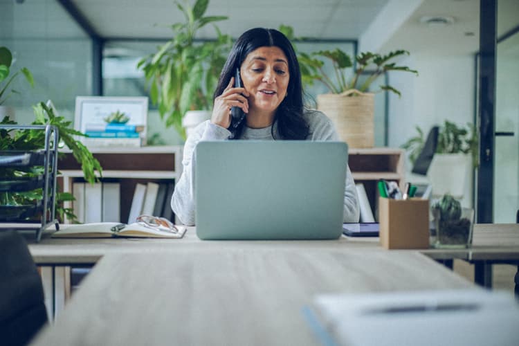 Business woman in office on laptop