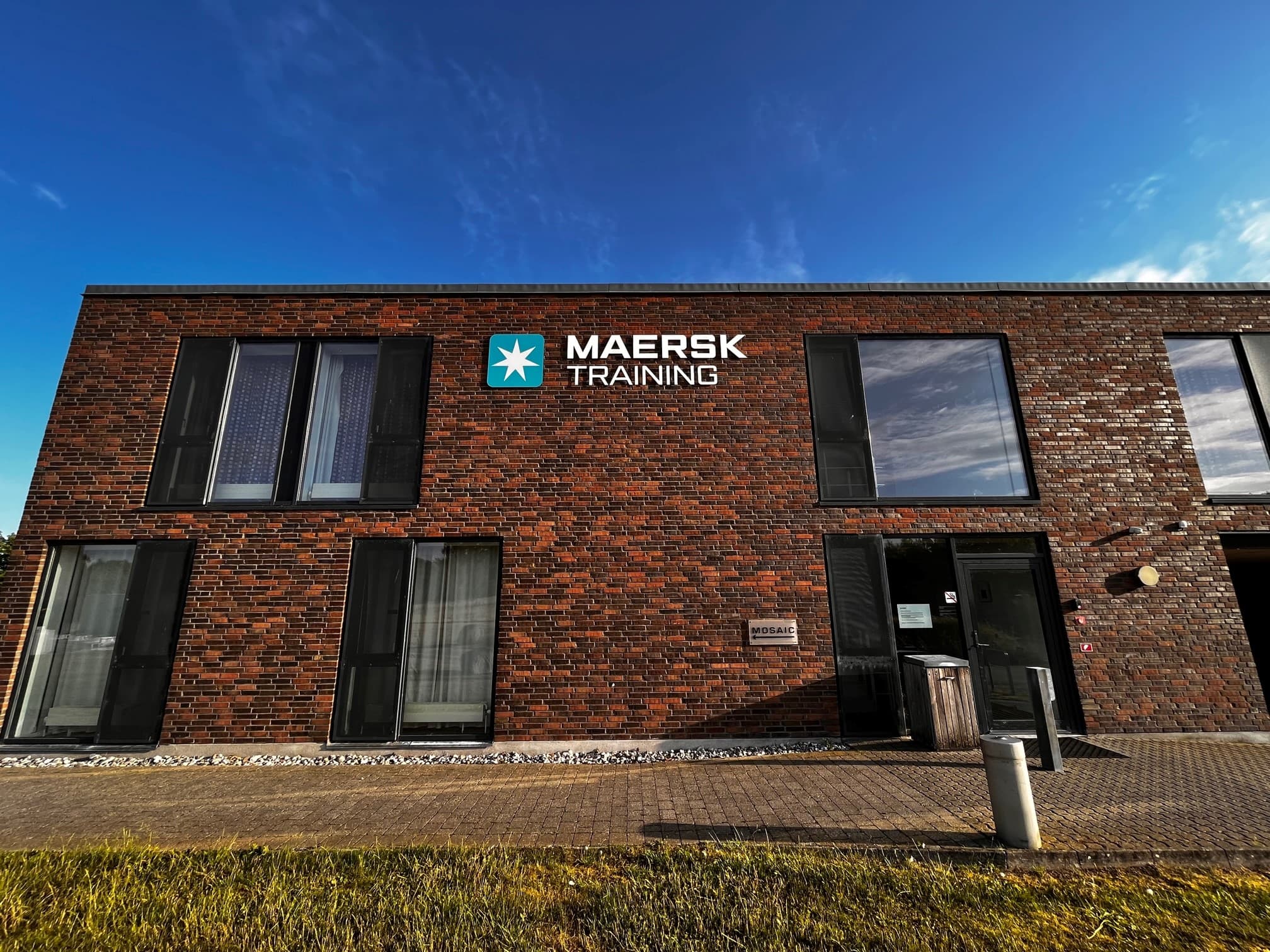 Maersk Training in Svendborg hotel on sunny day with Maersk Training logo