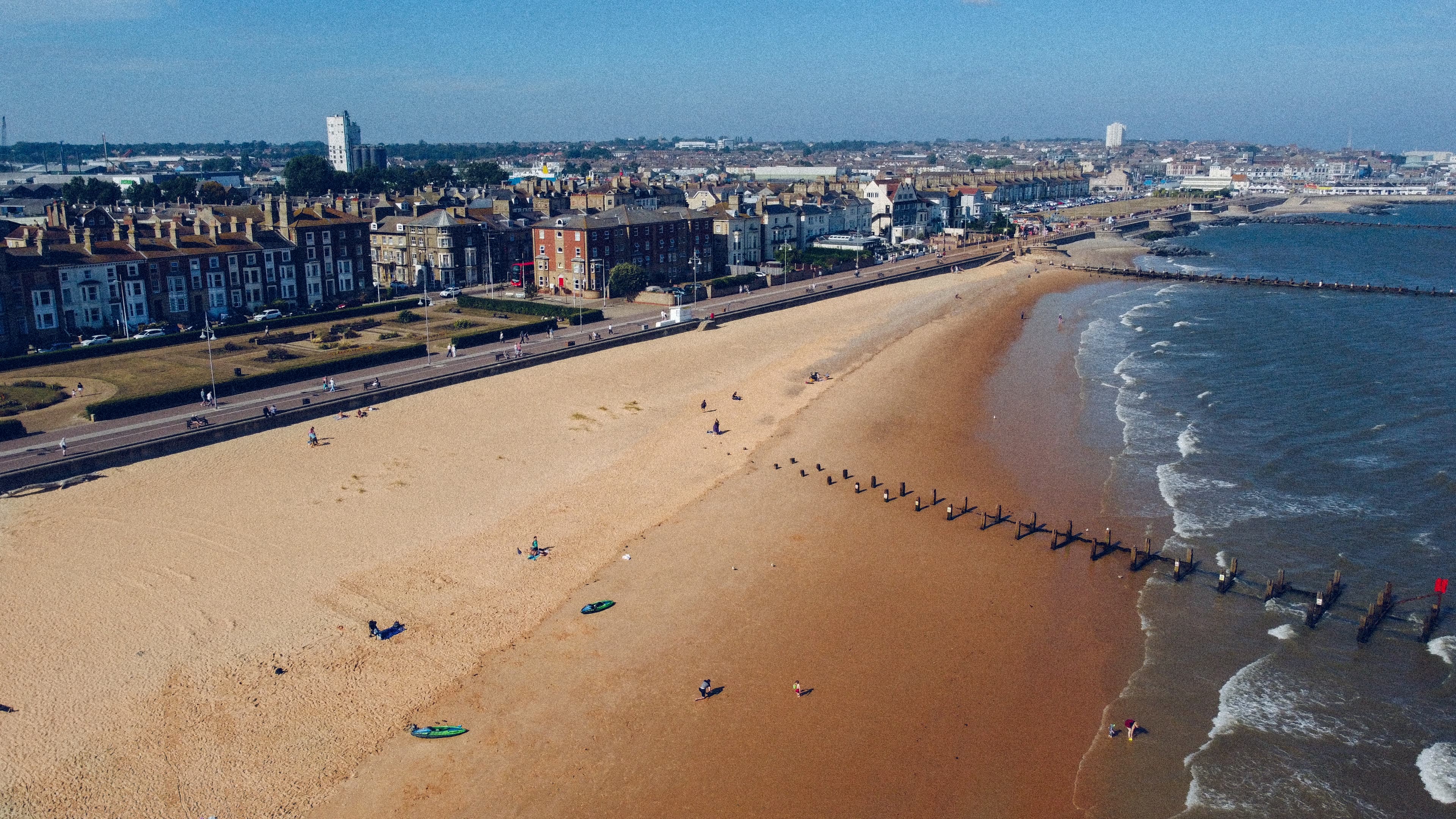 A sunny view of Lowestoft Beach, showcasing its wide sandy shores and scenic coastal promenade, a popular spot for leisure on the Suffolk coast.